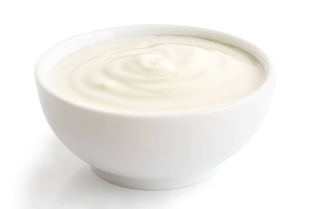 istock Ceramic bowl of white yoghurt isolated on white background. 545340086