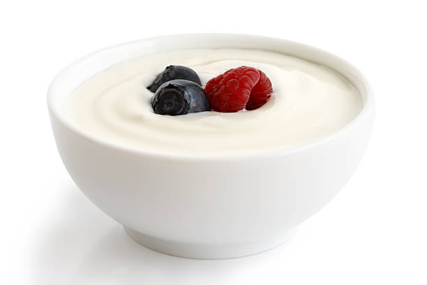 istock Bowl of white yoghurt with berries isolated on white bac 545340156