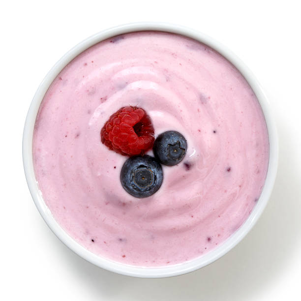 istock Ceramic bowl of fruit yoghurt with berries from above. 545340372
