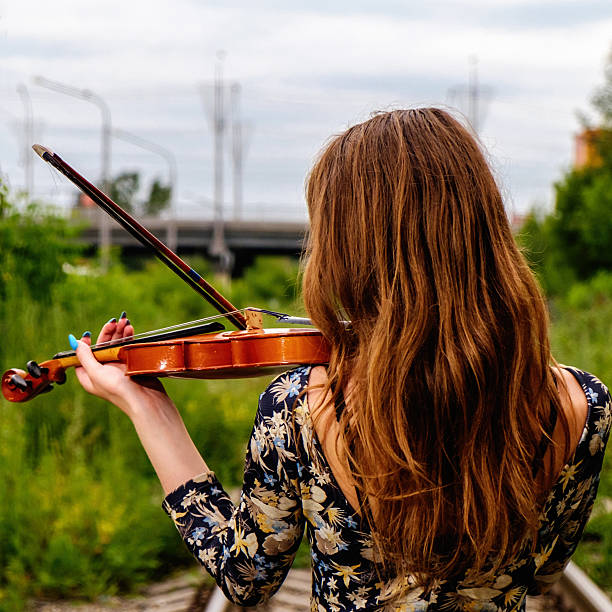 istock Beautiful girl with a violin 545341258