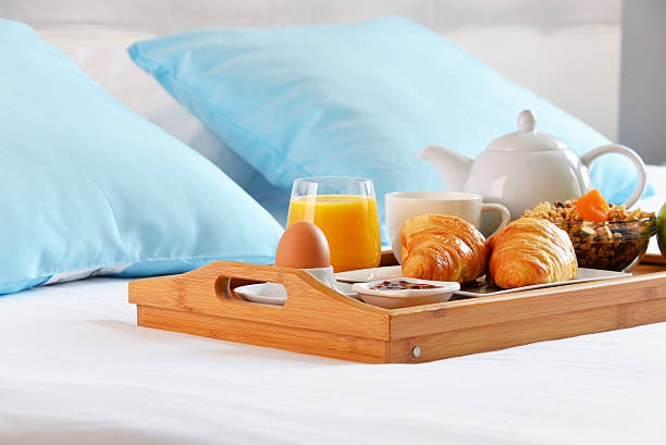 istock Breakfast on tray in bed in hotel room 545343820