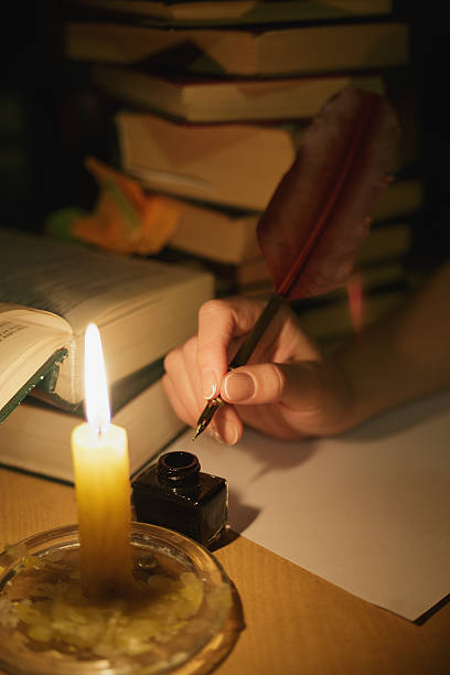 istock Feather in a hand by the light candle 545344288