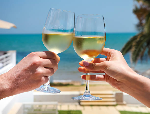 istock Man and woman clanging glasses with white wine 545346152