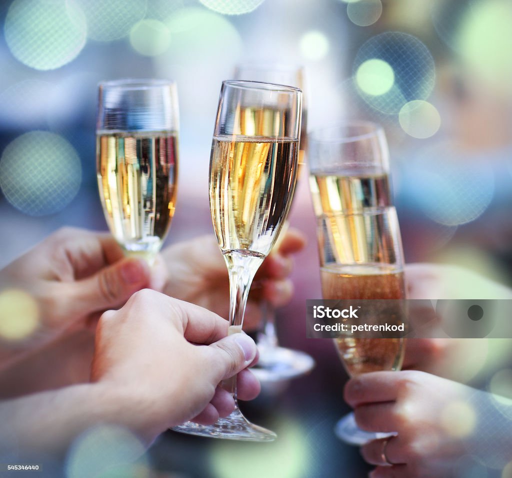 People holding glasses of champagne making a toast Celebration. People holding glasses of champagne making a toast Celebratory Toast Stock Photo