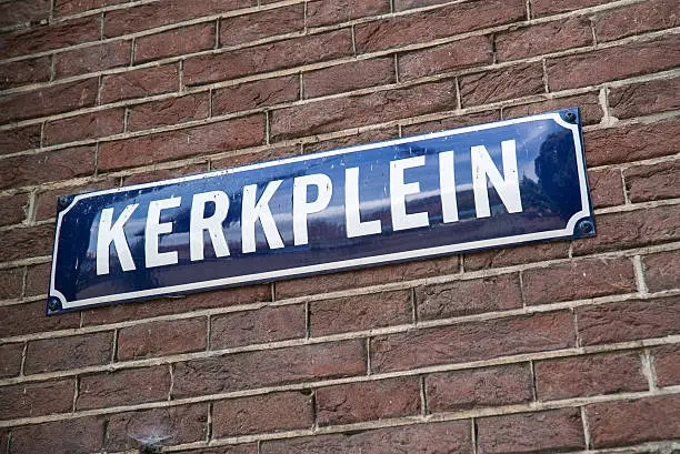 Authentic old fashion Dutch street sign on brick wall.