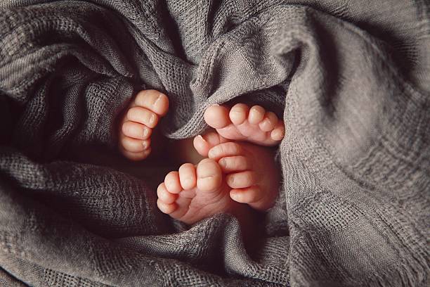 istock Tiny Toes of Newborn Twins 545347166