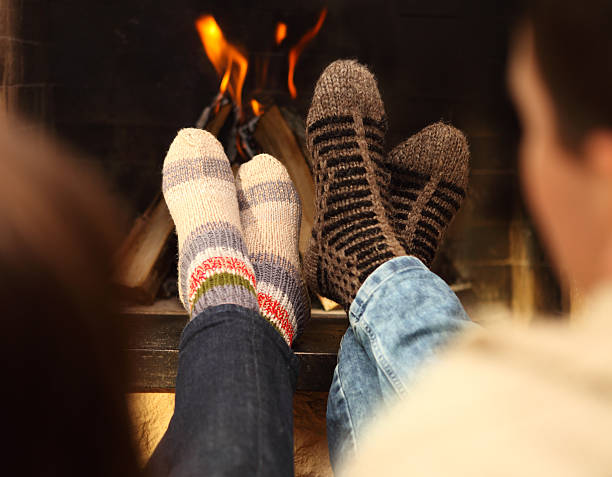 istock Couple in socks near the fireplace 545347218