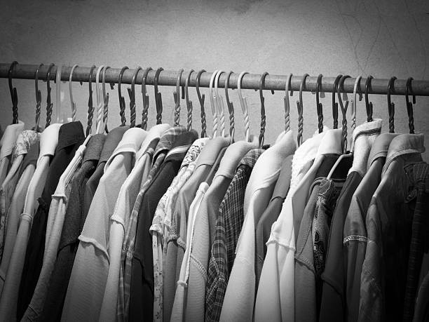 istock Black and white image of clothes hanging on hanger rack. 545347232
