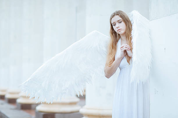 istock Girl with white angel wings 545347456