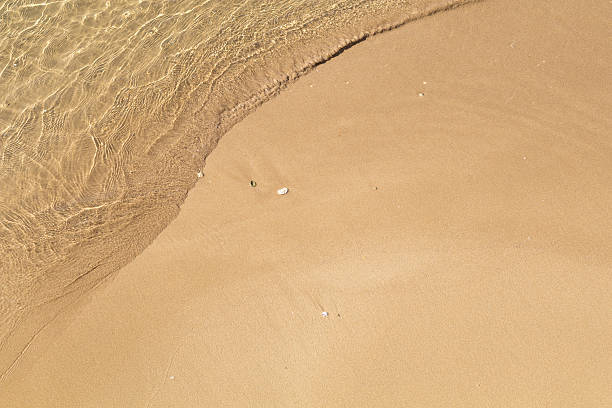 istock Beautiful crystal clear sea water, Gentle waves breaking on gold 545347992