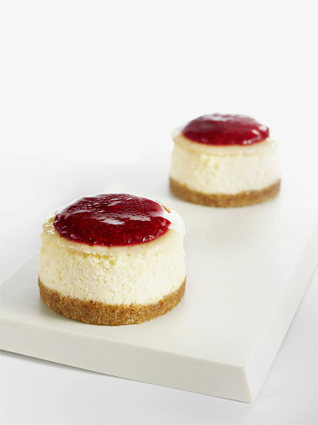 pieces of lstrawberry cheesecakes on white background