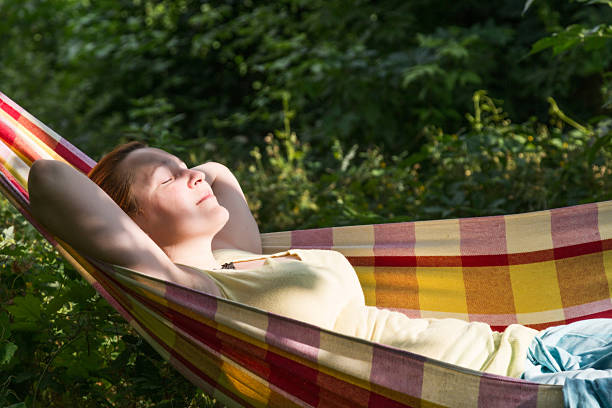 istock Person relaxing in Hummock at Summer Garden side View 545349746