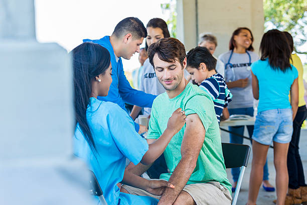 istock Free flu shot clinic with a handsome man recieving vaccination 545352590