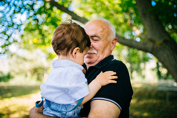istock Grandfather holding grandson 545353126