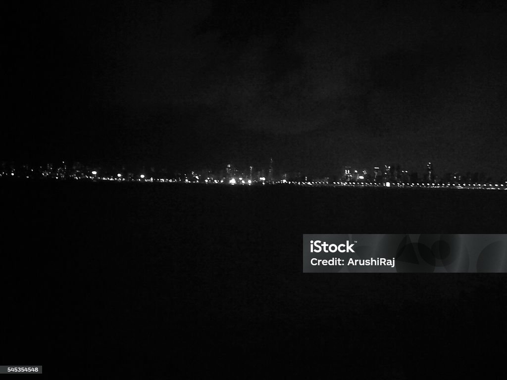 Queen's necklace Queen's Necklace is an alternate name for Marine Drive in Mumbai which at night looks like a necklace because of all the street lights. Black And White Stock Photo