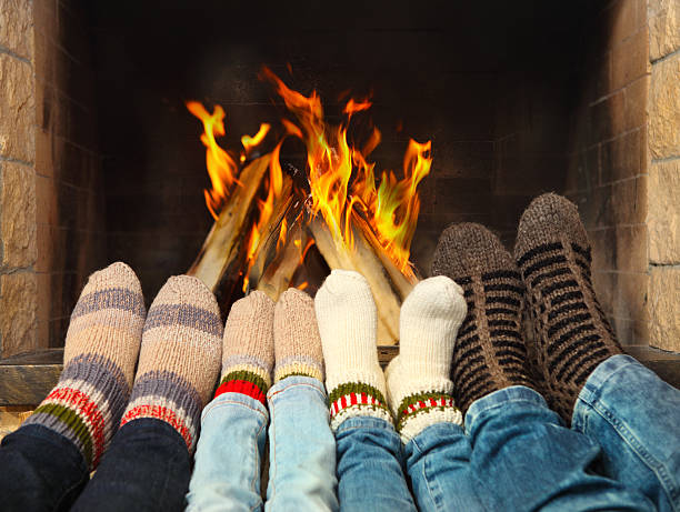 feet warming near the fireplace - aging process middle women men imagens e fotografias de stock