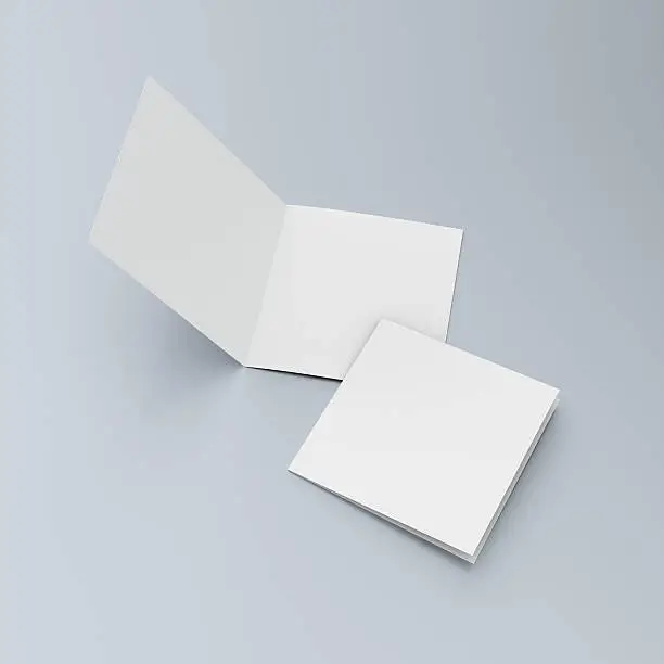 Photo of Square blank leaflets or brochures on blue