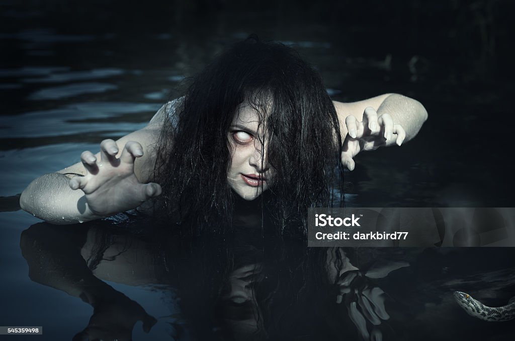 Terrible dead ghost woman in the water Terrible dead ghost woman in the water outdoor Spooky Stock Photo