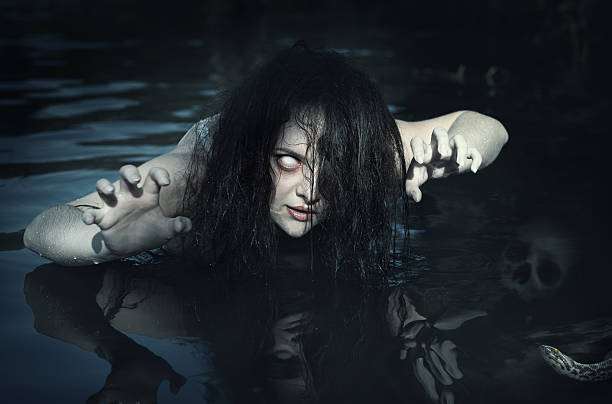 Terrible dead ghost woman in the water stock photo