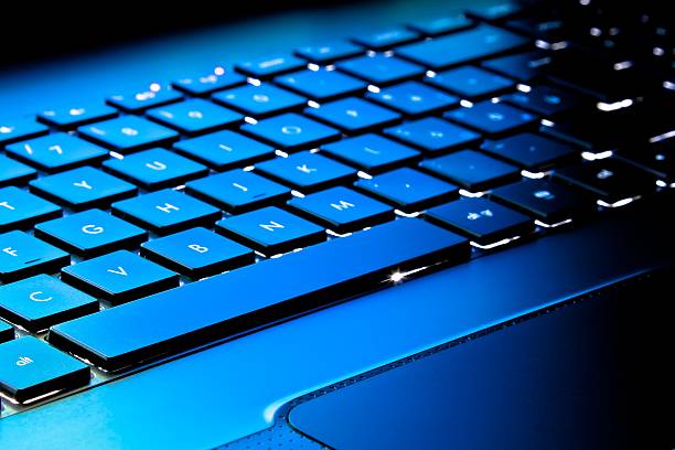istock laptop keyboard as a background toned to blue 545360754
