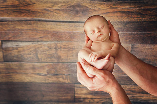 istock Newborn Baby in Father's Hands 545361206