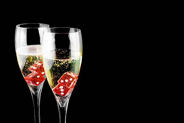 red dice in a champagne flute
