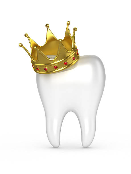 istock Human tooth with a gold crown on a white background. 545364268