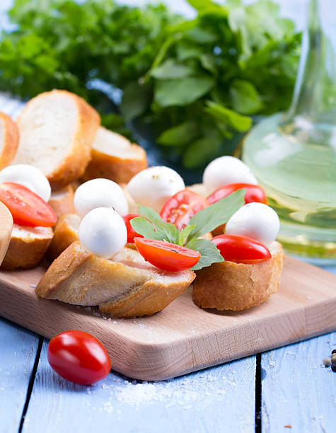 Caprese sandwiches of mozzarella cheese, tomato and basil Caprese sandwiches of mozzarella cheese, tomato and basil on a table sandwich new hampshire stock pictures, royalty-free photos & images