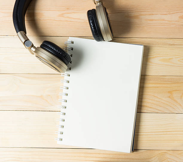 istock Blank note book binder with Golden music headphone. 545365090