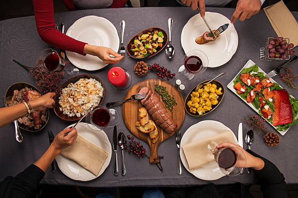 istock Top view of a dinner table and hands serving food 545368484