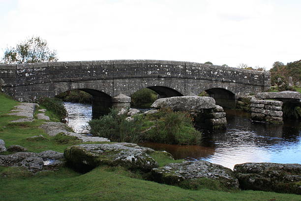 istock Dartmoor: Remains of Clapper Bridge in front of Road bridge. 545369308