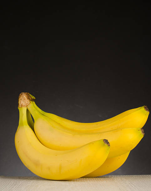 istock Fresh bananas on wooden background 545371224