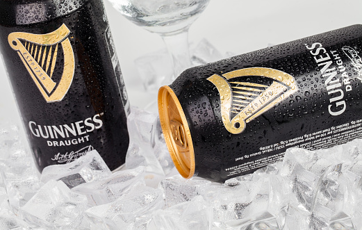 Trieste, Italy - July 8, 2016: Guinness stout aluminum can on the white background. Irish dry stout originated in the brewery of Arthur Guinness, Dublin. One of the most successful beer brands worldwide.