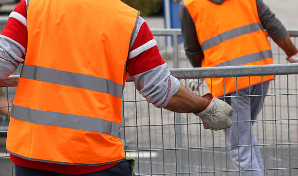 istock worker with  jacket and gloves moves hurdles before the concert 545372600