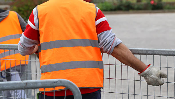 istock worker with high gloves moves hurdles before the concert event 545372732
