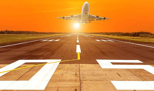 istock Silhouette airplane flying take off on sunset background 545372960