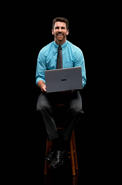 istock Smiling businessman working on laptop 545373020
