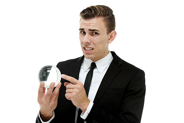 istock Scared businessman holding crystal ball 545373354