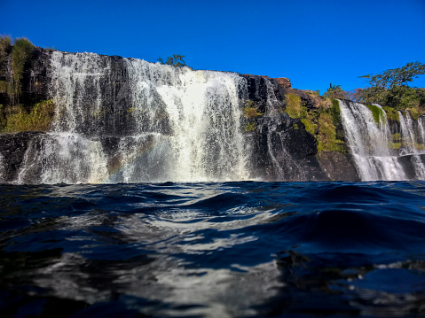 Waterfall in Minas Gerais State, Brazil, viewed from water level with close-up detail of the lake surface.