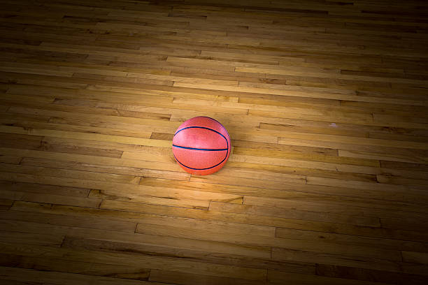 istock Basketball ball over floor in the gym 545376986