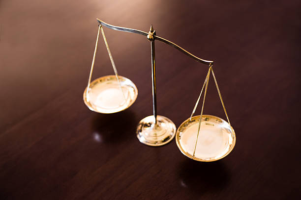 istock Justice balance on wooden table 545377024