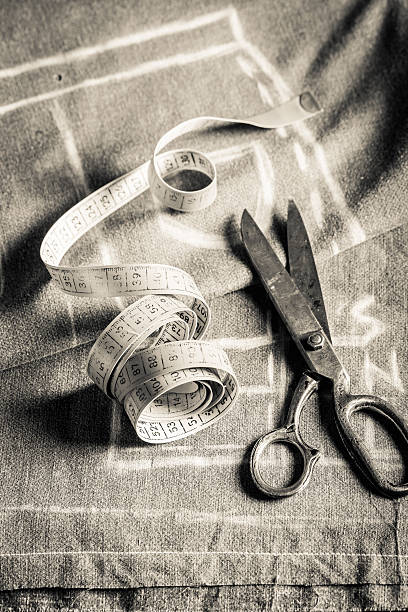 istock Closeup of cloth with scissors and tailor tape 545377576