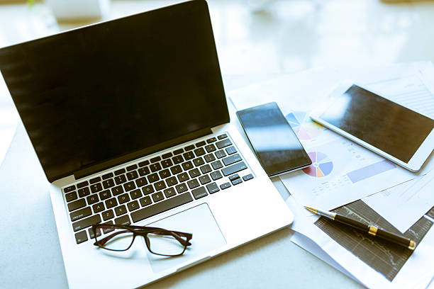 istock laptop and documents and phone in office 545420546