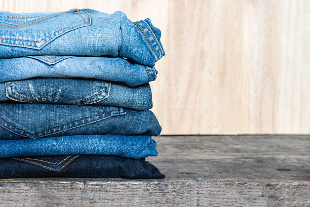 istock Jeans stacked on a wooden table 545420720