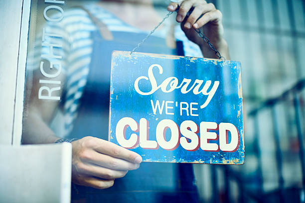 istock Barista hanging closed sign on window 545421714