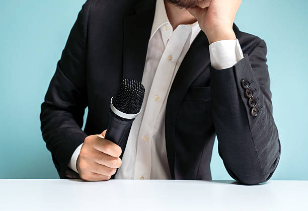 istock Asian businessman holding microphone 545424232