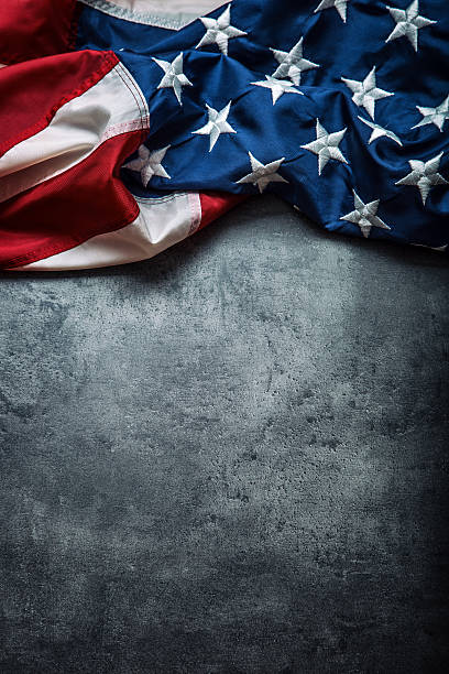 istock USA flag. American flag freely lying on concrete background. 545428582