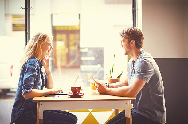istock Happy couple using technologies in trendy coffee shop 545429898