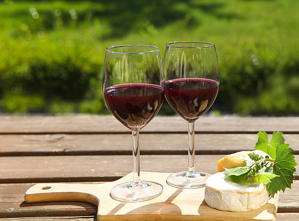 istock Various sorts of cheese and two red wine glasses 545430230