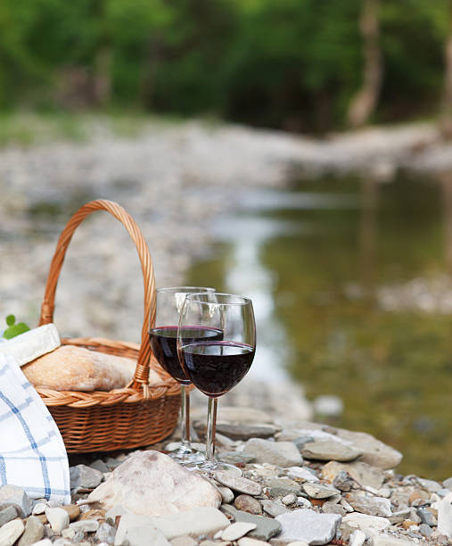 istock Red wine, cheese and bread served at a picnic 545430472